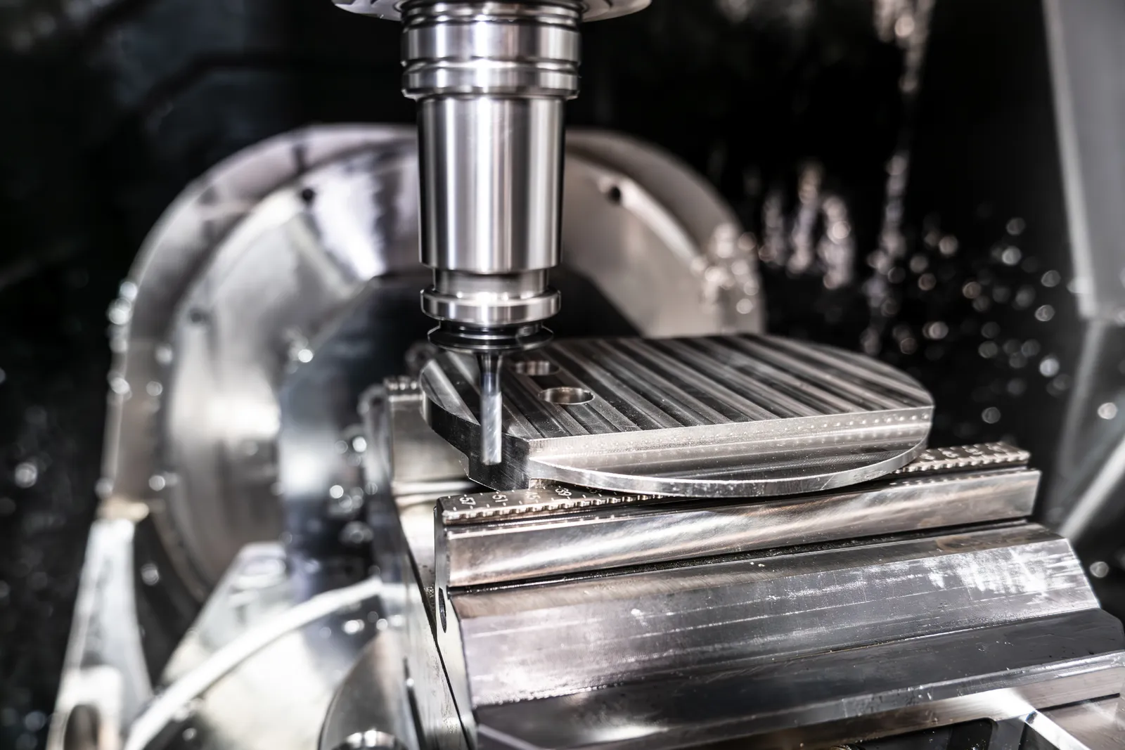 A 5-axis spindle cutting a part on an Ethereal Machines platform