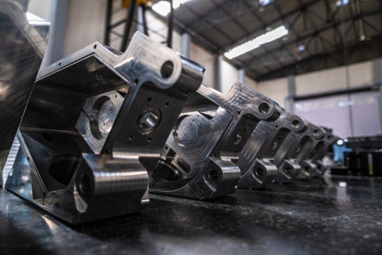 Row of machined aluminium aerospace brackets — Ethereal Machines